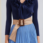 Close-up of blue dress with belted waist.